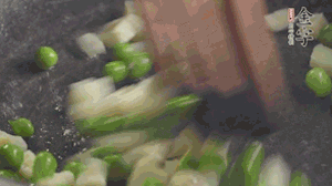 鍋中油7成熱時，入青豆、筍丁翻炒，然后加糯米飯加鹽均勻翻炒。