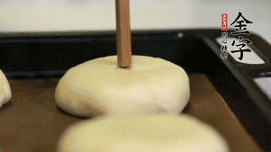 【包月餅】2．收口向下放在案板上，輕輕將月餅坯按扁，用筷子點紅點做裝飾?？鞠漕A熱至170℃，月餅放在中下層，烤17分鐘左右。