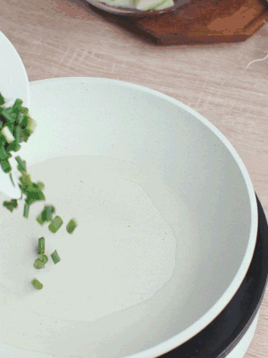 熱油下臘肉、蔥花煸炒，再下西葫蘆。