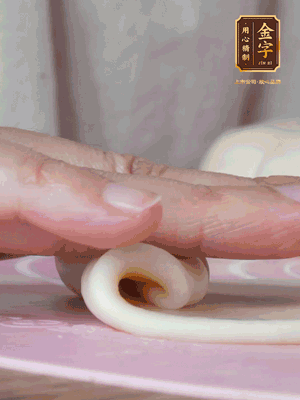 做面劑 油皮按扁，中間包入一個(gè)油酥，邊緣收緊捏死。包好的面劑按扁，用搟面杖搟壓成橢圓形。從底部向上卷成筒狀，用保鮮膜蓋好松弛15分鐘，再把筒狀縱向搟壓成長條狀。再卷一次，松弛20分鐘