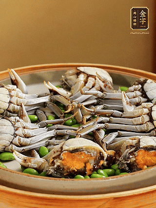 盤底鋪毛豆，依次放大閘蟹、咸肉， 淋一圈料酒、豉油。